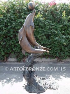 Game Play heroic bronze fine art gallery sculpture of leaping dolphins