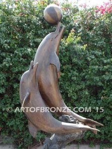 Game Play heroic bronze fine art gallery sculpture of leaping dolphins