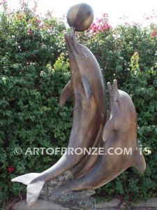 Game Play heroic bronze fine art gallery sculpture of leaping dolphins