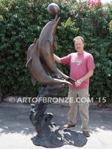 Game Play heroic bronze fine art gallery sculpture of leaping dolphins