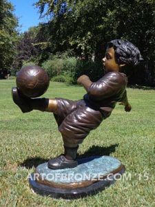 Lil Scorer sculpture of boy playing AYSO soccer bicycle kicking ball into goal