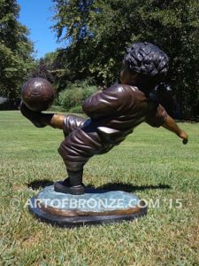 Lil Scorer sculpture of boy playing AYSO soccer bicycle kicking ball into goal