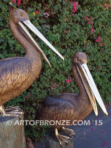 Pelican Pilings bronze statue of playful pelicans on bronze pilings