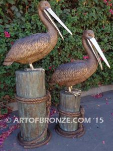 Pelican Pilings bronze statue of playful pelicans on bronze pilings