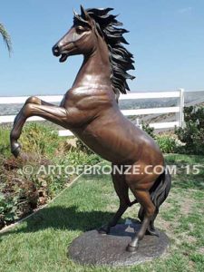 Thunderstorm sculpture of reared horse with forelegs off the ground and hind legs attached bronze base