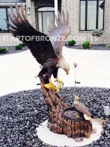 Dinner for Two* statue of a life-size bald eagle feeding its baby eaglet in nest