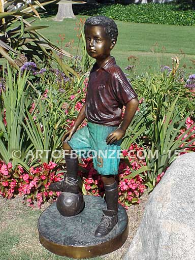Soccer Star bronze sculpture of AYSO soccer player getting ready to play his game