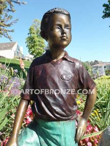 Bronze statue of standing AYSO boy with soccer uniform and soccer ball