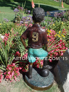 Soccer Star bronze sculpture of AYSO soccer player getting ready to play his game