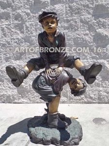 Leapfrog bronze sculpture of boy jumping over his brother