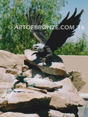 Frog Legs sculpture of outdoor bald eagle descending down to catch jumping frog