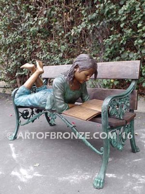 Best in Class bronze sculpture of young girl resting on bench reading her favorite novel