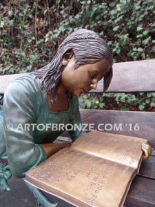 Best in Class bronze sculpture of young girl resting on bench reading her favorite novel