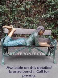 Best in Her Class bench bronze statue of girl lying down reading book