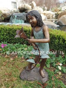 Summer Bloom bronze sculpture of girl holding sunflower