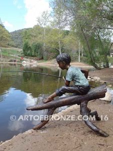 Fish n Day bronze sculpture of young boy sitting on log fishing