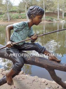 Fish n Day bronze sculpture of young boy sitting on log fishing