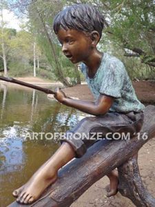 Fish n Day bronze sculpture of young boy sitting on log fishing