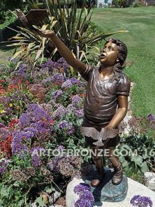 Faith and Hope bronze sculpture of young standing girl with doves in her hands
