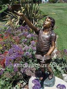 Faith and Hope bronze statue of young standing girl with doves in her hands