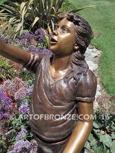 Faith and Hope bronze sculpture of young standing girl with doves in her hands