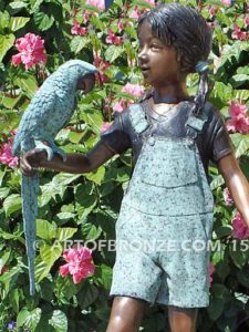 Pretty Bird bronze sculpture of girl in overall shorts with exotic bird on arm
