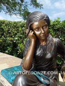 Big Sister Love closeup B bronze statue of two girls sitting and drawing