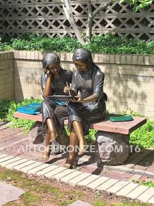 Big Sister Love DV bronze statue of two girls sitting and drawing