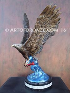 Bronze sculpture of flying eagle with captured salmon on custom marble base