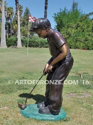 All Lined Up Bronze sports sculpture of golfer boy hitting ball with his putter
