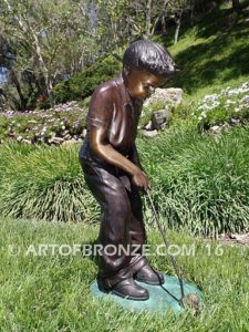 All Lined Up Bronze sports sculpture of golfer boy hitting ball with his putter