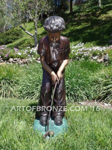 All Lined Up Bronze sports sculpture of golfer boy hitting ball with his putter