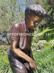 All Lined Up closeup Bronze statue of boy putting golf ball