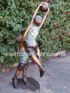 Takin it to the Hoop bronze sculpture of junior basketball players dunking