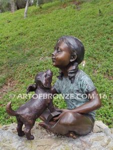 Give me Attention bronze statue girl sitting down playing with puppy dog on her lap