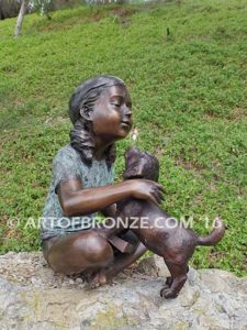 Give me Attention bronze statue girl sitting down playing with puppy dog on her lap