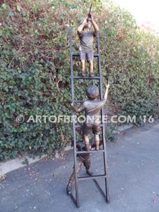 Team Work bronze sculpture of two boys climbing ladder working on house