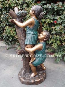 Baby Rescue Bronze Statue of kids playing together rescuing baby birds in tree