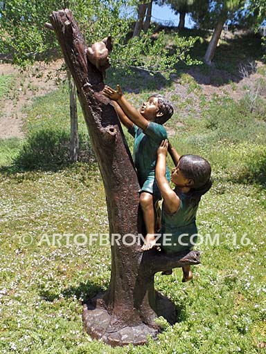Big Rescue Bronze statue of boy and girl rescuing with cat in tree