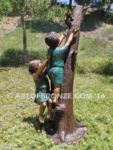 Big Rescue back view B Bronze statue of boy and girl rescuing with cat in tree