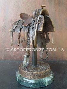 A Good Days Work bronze sculpture of western horse saddle attached to a marble base