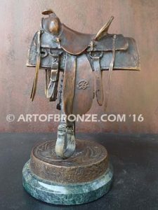 A Good Days Work bronze sculpture of western horse saddle attached to a marble base