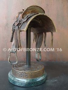 A Good Days Work bronze sculpture of western horse saddle attached to a marble base