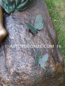 Butterfly Enchantment closeup C bronze sculpture of three kids sitting on log with butterfly net