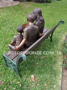 Making a Difference bronze sculpture of four children sitting on bench reading a book