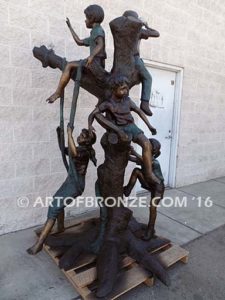 Kids in a tree bronze sculpture of kids climbing in tree for school park