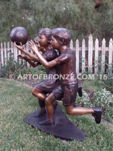 Playing Ball bronze sculpture of girl and two boys juggling ball