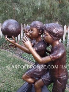 Playing Ball bronze sculpture of girl and two boys juggling ball