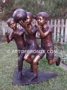 Playing Ball bronze sculpture of girl and two boys juggling ball