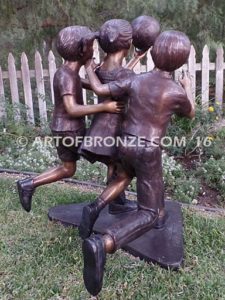 Playing Ball bronze sculpture of girl and two boys juggling ball